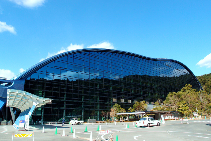 空の青と、山の緑を映しだすミラーガラス張りの壁面 空の青と、山の緑を映しだすミラーガラス張りの壁面
