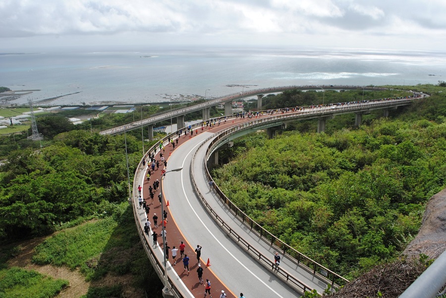 絶景スポットのニライカナイ橋を走るジョガー 絶景スポットのニライカナイ橋を走るジョガー