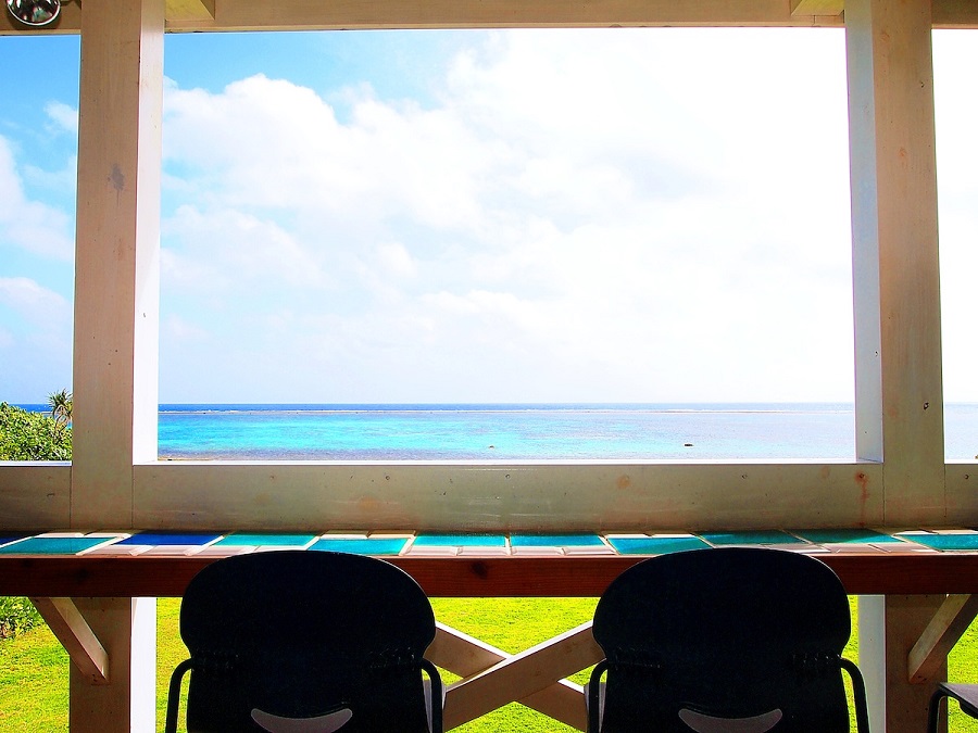 PUFF PUFFのテラス席。真っ青な海と空そして雲が浮かぶ